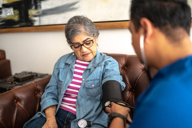 Nurse measuring the senior woman pressure at nursing home